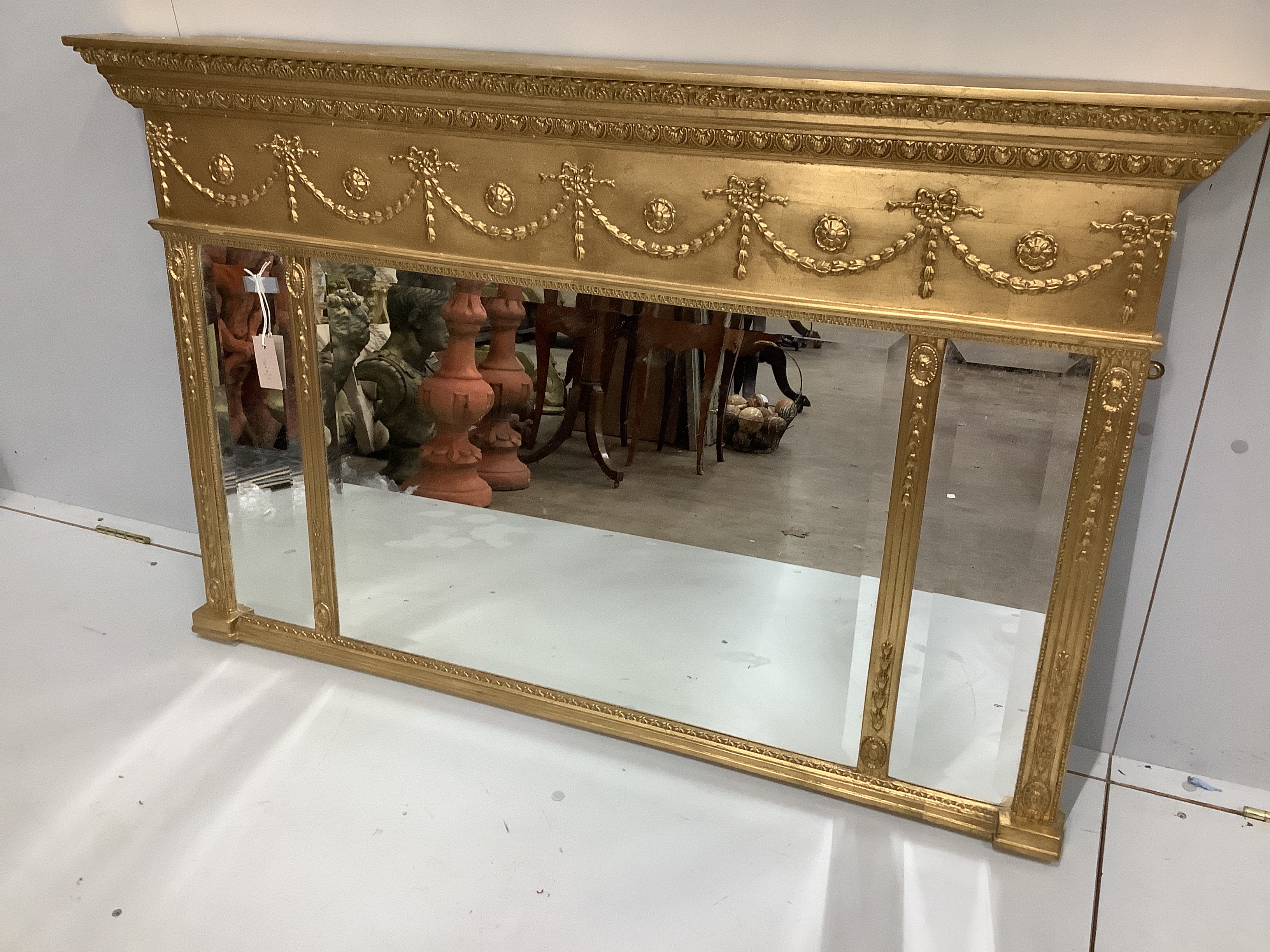 A reproduction Victorian style gilt framed triple plate overmantel mirror, width 130cm, height 81cm